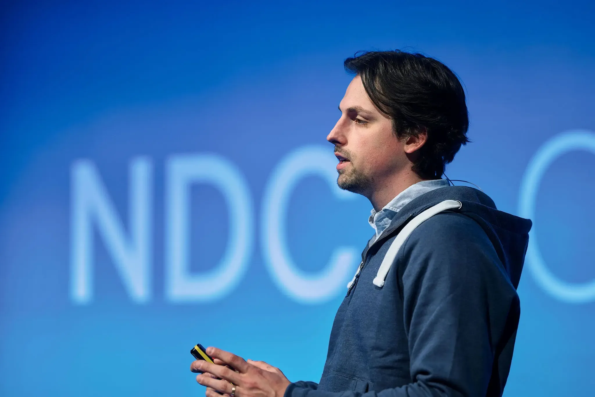 Tim Damen speaking on stage at NDC Oslo